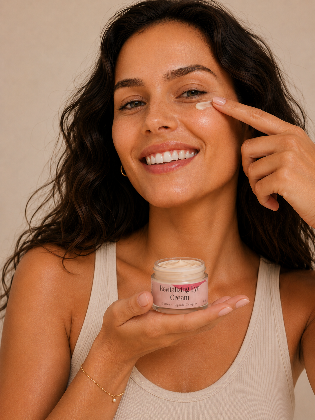 Woman applying cream to her face with a jar of cream in her hand against a neutral background
